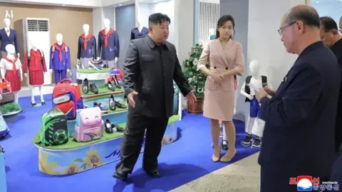 KCNA Kim Jong Un with his daughter Kim Ju Ae addressing officials